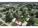 Aerial view showcases the home's location in a residential neighborhood with mature trees at 455 Manor Dr, Bartow, FL 33830