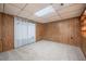 Finished basement area featuring carpet, wood paneling, and ample lighting at 455 Manor Dr, Bartow, FL 33830