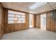 Cozy finished basement with wood paneling and open shelving at 455 Manor Dr, Bartow, FL 33830