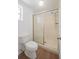 Cozy bathroom features a toilet and shower with sliding glass doors and a chrome shower head at 455 Manor Dr, Bartow, FL 33830