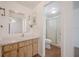 Bathroom vanity with wood cabinets and a shower through the doorway at 455 Manor Dr, Bartow, FL 33830
