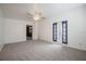 Spacious bedroom with neutral carpet, ceiling fan, and patio door access at 455 Manor Dr, Bartow, FL 33830
