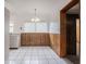 Bright dining area featuring wood paneling, white tile floors, and ample light at 455 Manor Dr, Bartow, FL 33830