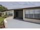 Close-up of the covered front porch featuring painted concrete and brick accents at 455 Manor Dr, Bartow, FL 33830