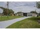 Beautiful single-story house with a long driveway surrounded by a well-maintained lawn at 455 Manor Dr, Bartow, FL 33830