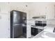 Efficient kitchen featuring white cabinets and stainless steel appliances at 455 Manor Dr, Bartow, FL 33830