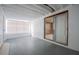 Well-lit bonus room with white walls, concrete flooring, and sliding glass doors to the exterior at 455 Manor Dr, Bartow, FL 33830