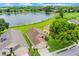 Aerial view of a home near a lush green golf course and a scenic lake at 464 Lake Suzanne Dr, Lake Wales, FL 33859