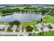 Aerial view of a lakeside home with mature trees and a well-maintained yard at 464 Lake Suzanne Dr, Lake Wales, FL 33859