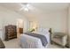 Bright bedroom boasts neutral colors, vaulted ceilings, and an adjacent ensuite bathroom at 464 Lake Suzanne Dr, Lake Wales, FL 33859