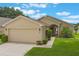 A well-manicured lawn and tasteful landscaping highlight the exterior of this charming single-Gathering home at 464 Lake Suzanne Dr, Lake Wales, FL 33859