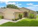 Charming single-story home with an attached garage, well-manicured lawn, and landscaping at 464 Lake Suzanne Dr, Lake Wales, FL 33859