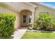 The front entrance is showcased with an arched entry, mature landscaping, and walkway at 464 Lake Suzanne Dr, Lake Wales, FL 33859