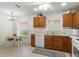 Charming kitchen features wood cabinets, white appliances, and a bright dining nook with natural light at 464 Lake Suzanne Dr, Lake Wales, FL 33859