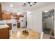 Eat-in kitchen with wood cabinets, white appliances, and a casual dining area at 464 Lake Suzanne Dr, Lake Wales, FL 33859