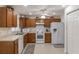 Functional kitchen featuring white appliances, wood cabinets, and ample counter space at 464 Lake Suzanne Dr, Lake Wales, FL 33859
