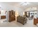 Open-concept living room with an adjacent kitchen, comfortable seating, and neutral decor at 464 Lake Suzanne Dr, Lake Wales, FL 33859