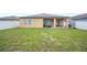 The backyard features a green lawn, a patio with outdoor furniture and a white vinyl fence at 4662 Osprey Way, Winter Haven, FL 33881