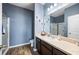 This bathroom features blue walls, wood floors, and a glass-enclosed shower at 4662 Osprey Way, Winter Haven, FL 33881