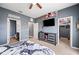 This bedroom features gray walls, a flat screen TV, and a walk-in closet at 4662 Osprey Way, Winter Haven, FL 33881