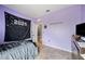 Bedroom with light purple walls with tile flooring, a door and small decorations at 4662 Osprey Way, Winter Haven, FL 33881
