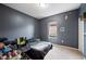 Bedroom with dark gray walls, carpet, small window, desk and chair at 4662 Osprey Way, Winter Haven, FL 33881