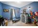 bedroom with castle decor, carpet flooring, window with gray curtains, and blue walls at 4662 Osprey Way, Winter Haven, FL 33881
