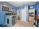 bedroom with castle decor, blue walls, two doorways, and carpet flooring at 4662 Osprey Way, Winter Haven, FL 33881