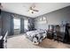 Spacious bedroom featuring a ceiling fan, carpet flooring, natural light, and modern decor at 4662 Osprey Way, Winter Haven, FL 33881