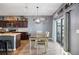 Bright dining area with a view, a kitchen island with granite countertops, and stainless steel appliances at 4662 Osprey Way, Winter Haven, FL 33881