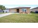Inviting single-Gathering home with a green lawn and simple, pleasing landscaping at 4662 Osprey Way, Winter Haven, FL 33881