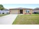 Well-maintained front yard featuring a lush lawn and tidy landscaping at 4662 Osprey Way, Winter Haven, FL 33881