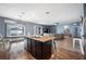 Open-concept kitchen with a large island, granite countertops, and seamless flow into the dining and living areas at 4662 Osprey Way, Winter Haven, FL 33881