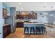 Modern kitchen with a large island and dark wood cabinetry at 4662 Osprey Way, Winter Haven, FL 33881