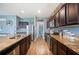 Spacious kitchen features dark wood cabinetry, granite countertops, stainless steel appliances, and stylish fixtures at 4662 Osprey Way, Winter Haven, FL 33881