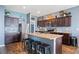 Stylish kitchen featuring an island with bar seating and stainless steel appliances at 4662 Osprey Way, Winter Haven, FL 33881