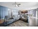 Open-concept living room with a sectional sofa seamlessly flowing into the kitchen at 4662 Osprey Way, Winter Haven, FL 33881