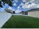 Spacious backyard featuring a privacy fence, lush lawn, and a covered patio perfect for outdoor relaxation at 4747 Mandolin Loop, Winter Haven, FL 33884