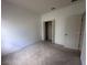 Simple bedroom featuring neutral carpet, a closet, and a door at 4747 Mandolin Loop, Winter Haven, FL 33884