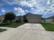Charming single-story home featuring a spacious front yard, driveway, and attached two-car garage at 4747 Mandolin Loop, Winter Haven, FL 33884