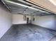 Spacious and clean garage interior showing the ceiling structure and utility connections at 4747 Mandolin Loop, Winter Haven, FL 33884