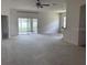 Spacious living room featuring neutral carpet, sliding glass doors, and open layout at 4747 Mandolin Loop, Winter Haven, FL 33884