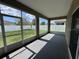 Covered and screened patio providing an outdoor sitting area with views of the backyard and fencing at 4747 Mandolin Loop, Winter Haven, FL 33884