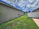 A view of a side yard with a well-maintained lawn, offering outdoor space for activities or landscaping at 4747 Mandolin Loop, Winter Haven, FL 33884