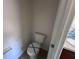 Enclosed toilet room featuring a toilet, vanity with sink, and a mirrored medicine cabinet at 4747 Mandolin Loop, Winter Haven, FL 33884
