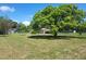 The backyard boasts lush greenery and mature trees, offering privacy and natural beauty at 514 7Th S St, Dundee, FL 33838