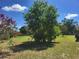 The backyard boasts lush greenery and mature trees, offering privacy and natural beauty at 514 7Th S St, Dundee, FL 33838