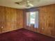 Standard bedroom features include ceiling fan, window, carpeting, and paneling at 514 7Th S St, Dundee, FL 33838