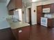 Fully equipped kitchen with wood cabinets, stainless steel sink, and island seating, designed for functionality at 514 7Th S St, Dundee, FL 33838