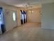 Bright living room featuring tile floors, blue curtains, and a chandelier, creating a welcoming atmosphere at 514 7Th S St, Dundee, FL 33838